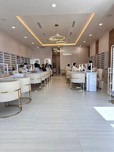 Mimi Mai Nail Spa main floor with manicure stations and polish wall