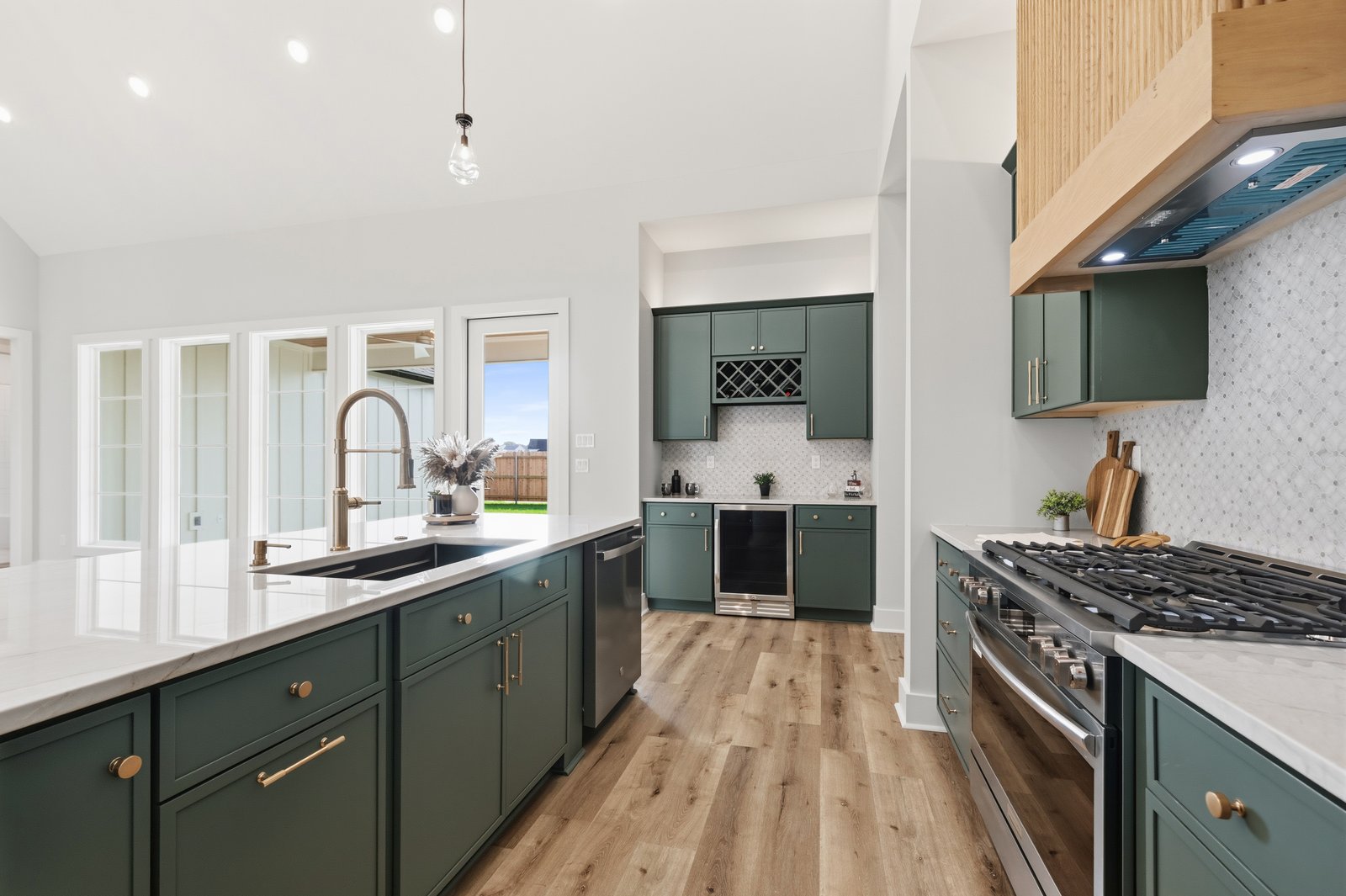 Kitchen with green cabinetry and gas range
