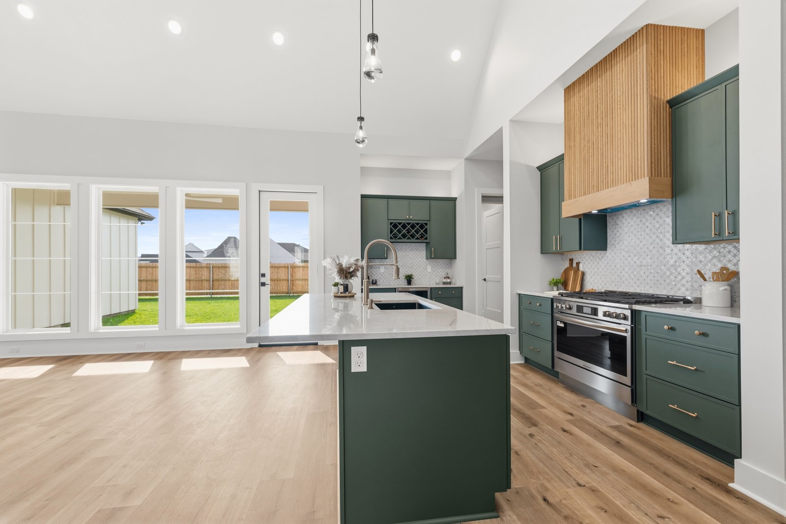 Butler pantry with green cabinets and beverage cooler