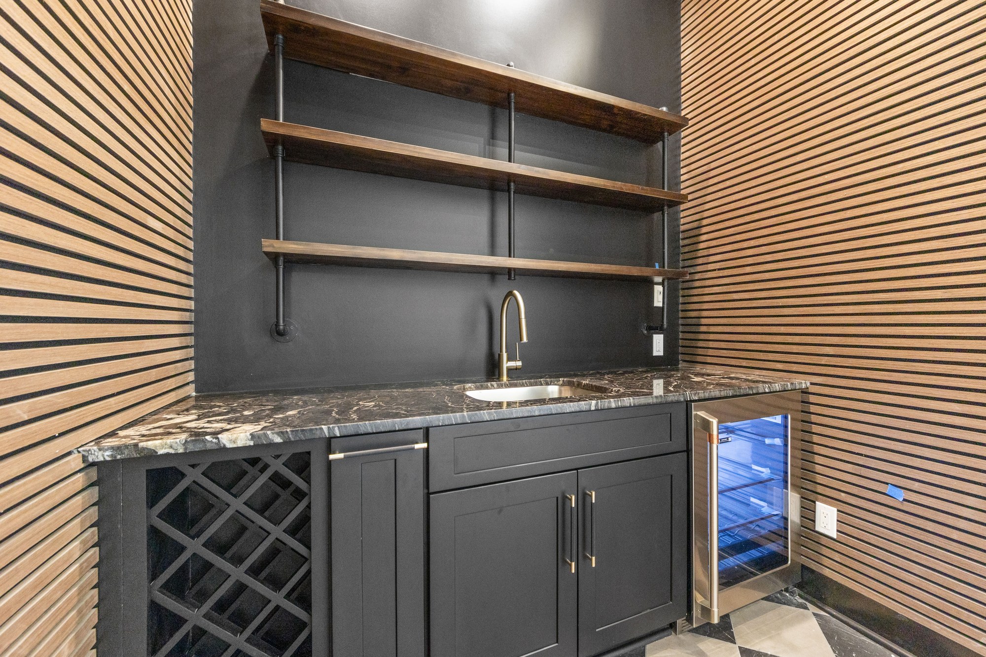 Custom bar cabinetry with a contrasting tile floor at 221 Gunter Grass