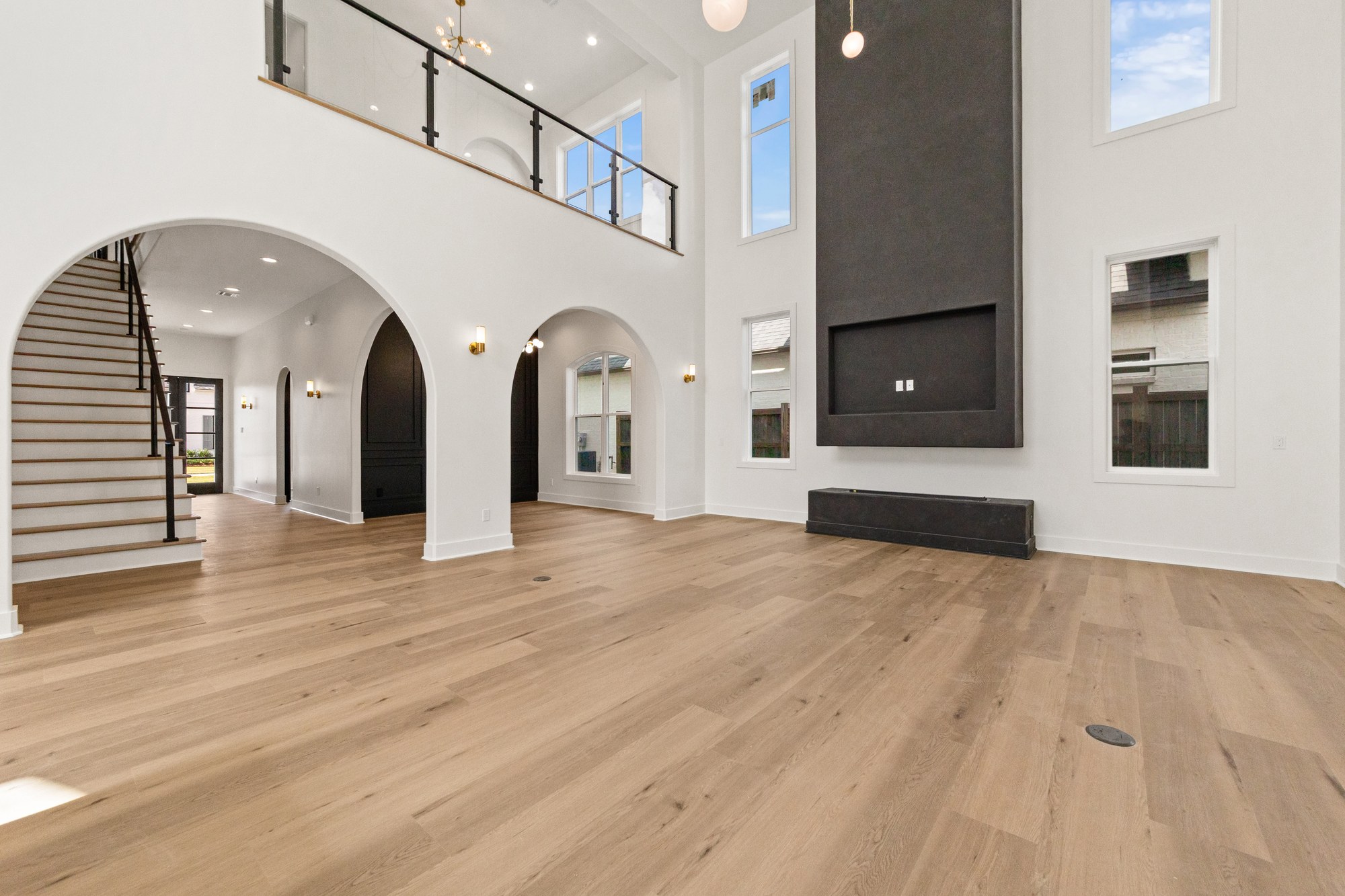 Double-height living room with a statement fireplace at 221 Gunter Grass