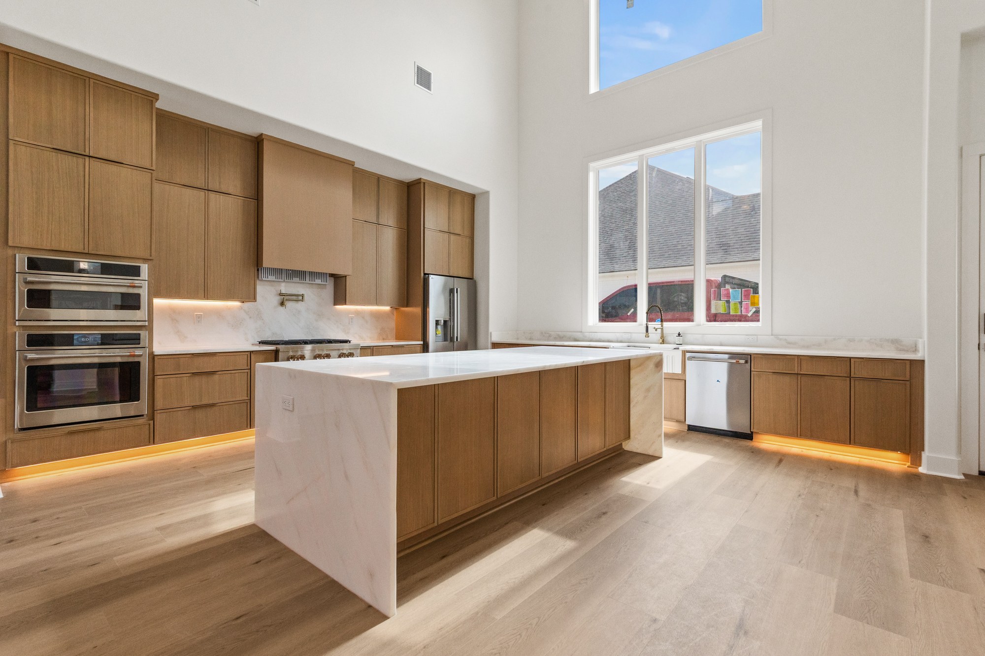 Wood cabinetry, a generous island, and bright natural light at 221 Gunter Grass